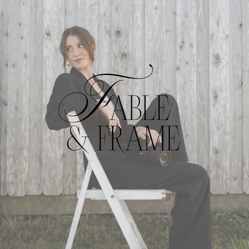 Madyson Call, photographer and owner of Fable and Frame Studio, seated with her camera against a weathered wood backdrop